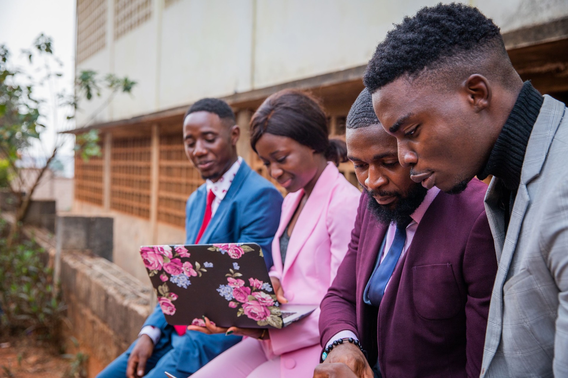 Four African business people during a meeting work discussing and using the laptop