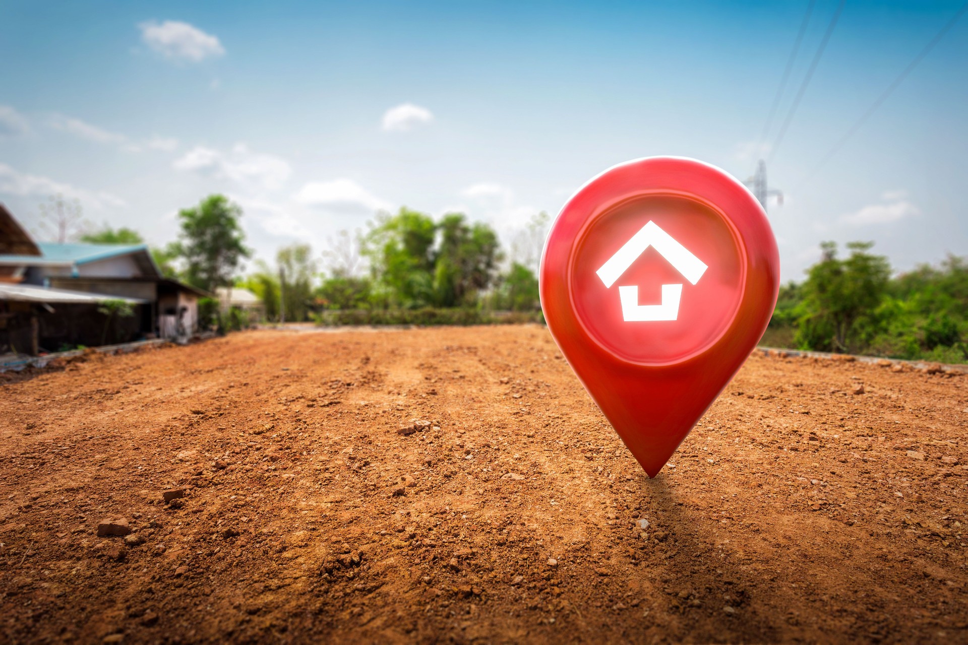 Symbole de la maison avec icône d’épingle d’emplacement sur un sol de récupération de marais sec et craquelé vide dans un concept de vente immobilière ou d’investissement immobilier.